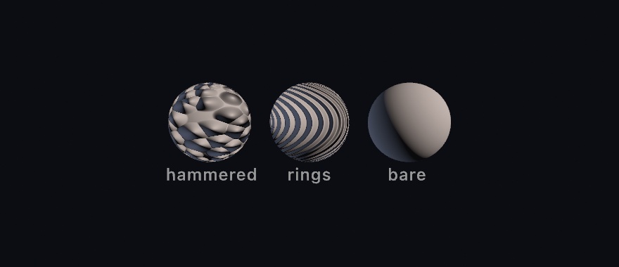 Three gray spheres under the same warm light: one hammered with soft dents, one engraved with concentric rings, and one bare, all with perfectly circular silhouettes