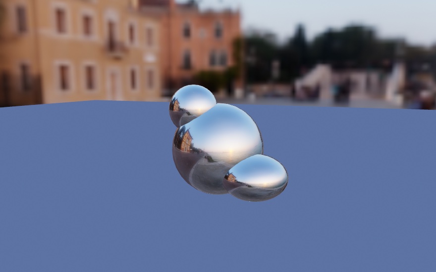 The same three chrome balls in the same position, now under a warm evening HDRI of Venice. Ochre buildings and trees fill the background, and the buildings are clearly visible reflected in the left flank of the largest ball