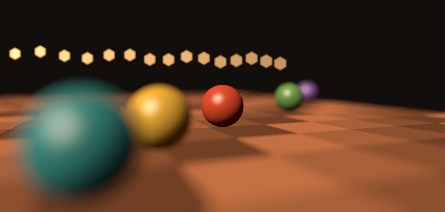 Five balls standing on a wooden floor at five distances, with the lens focused on the red one in the middle: the red ball and the floor around it are sharp, the teal ball nearest the camera is soft and spreads past its own edge over the floor, the yellow one is a little soft, the green and violet ones behind soften, and a string of small lamps along the back opens into six-sided discs